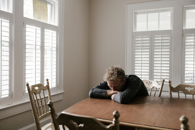 A man contemplating sitting at a table regarding spotting adhd in adults