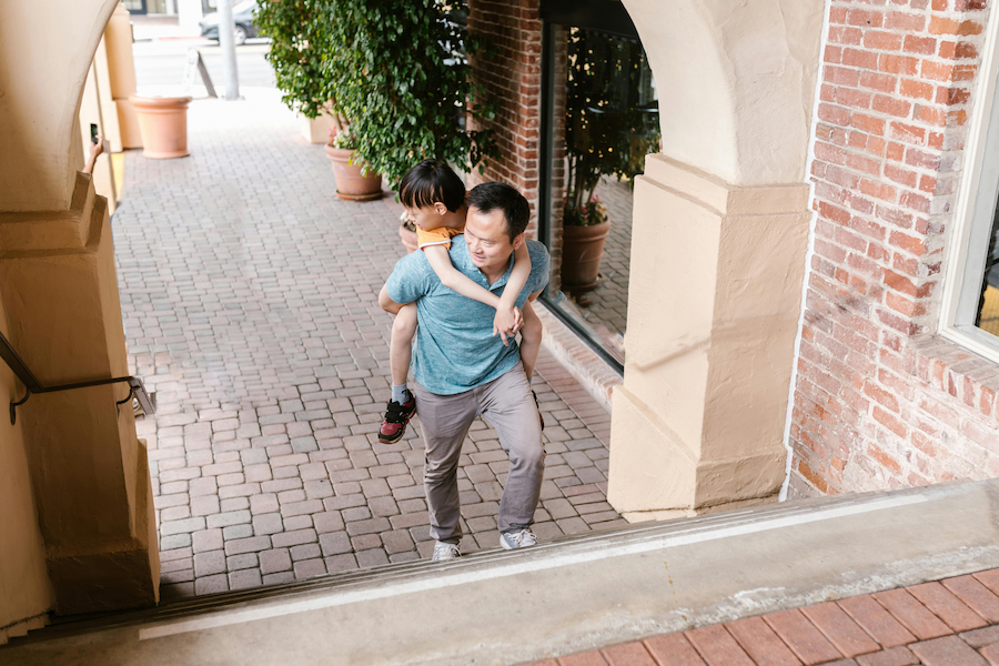 dad carrying autistic son